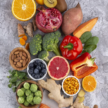 A variety of fruits and vegetables are arranged in a circle