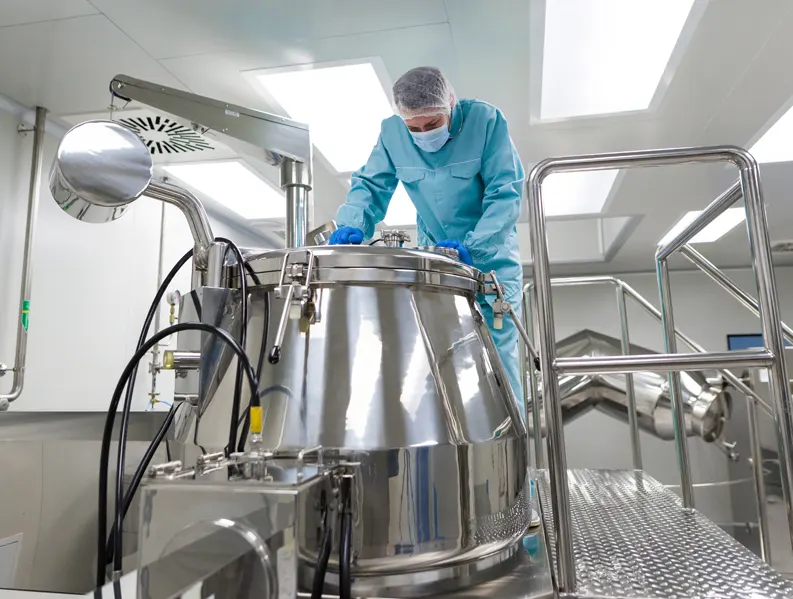 A man in a lab setting up a machine